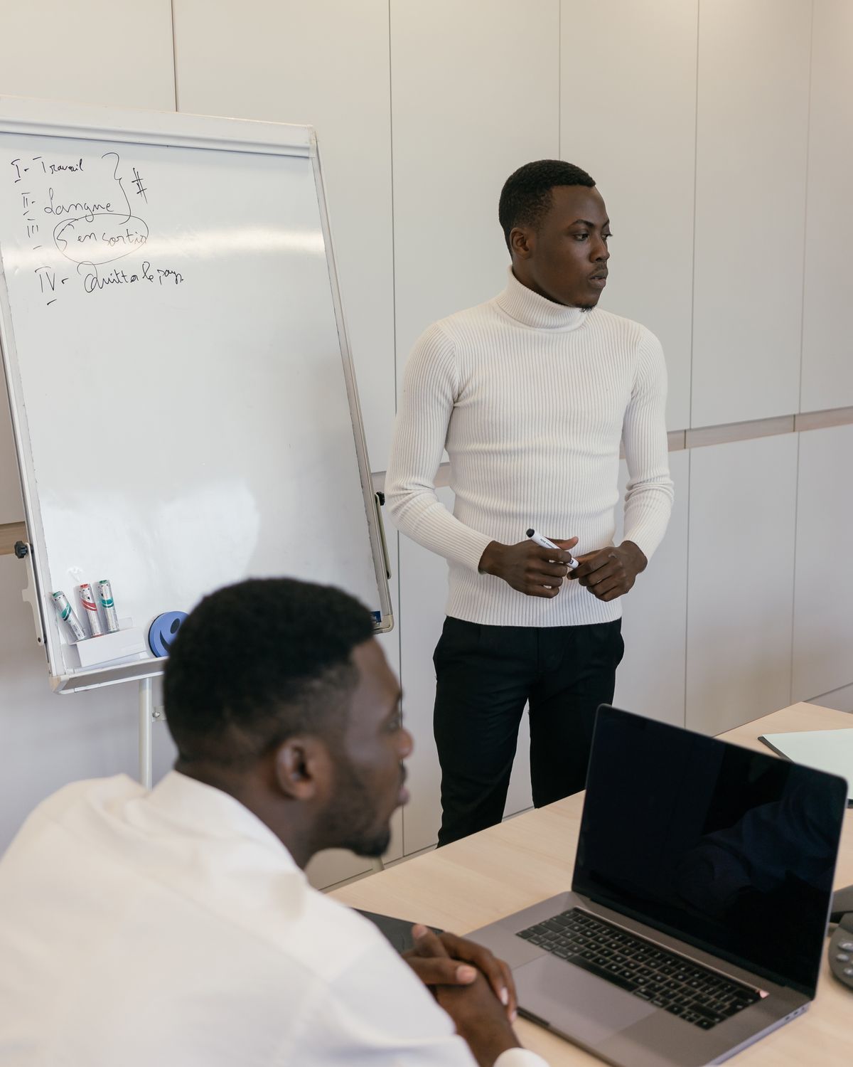 Consultant leading a strategy session with a colleague